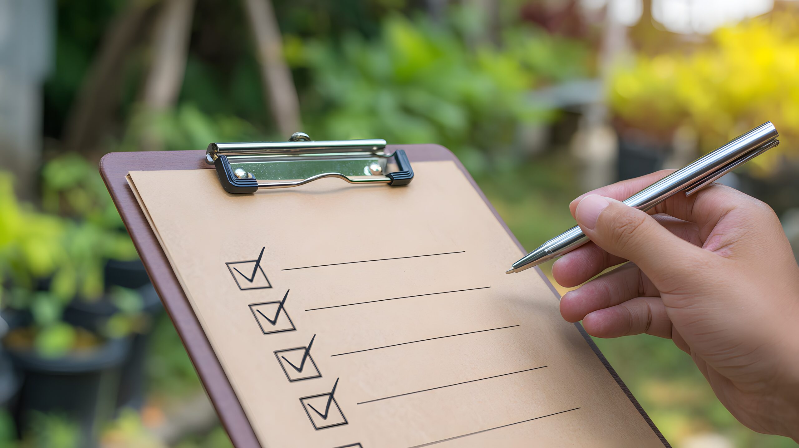 A collection of essential tools for concrete pond repair including an angle grinder, scrub brushes, and Pond Shield epoxy