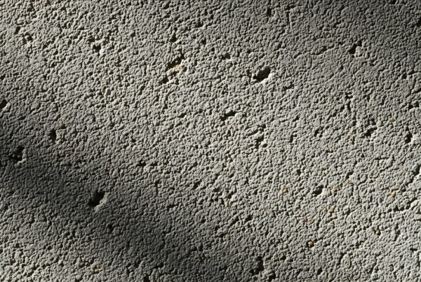Close up of a rough, pitted concrete pond surface requiring smoothing before applying Pond Shield epoxy