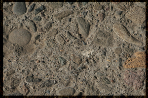 Rough exposed aggregate concrete surface before pond shield